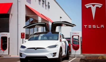 A model X parked in front of a Tesla dealership