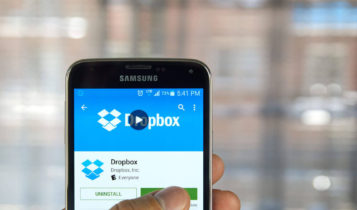 hand holding a phone showing the dropbox app